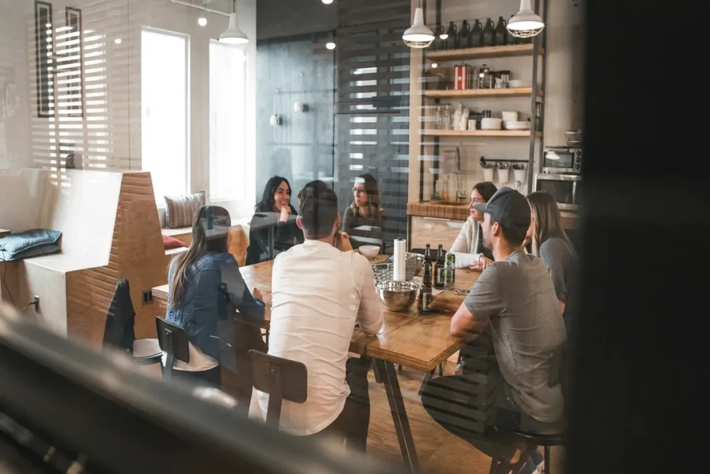 Reunião de equipe em escritório moderno, com foco em onboarding e colaboração.
